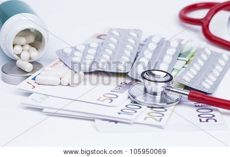 Pills stethoscope and money