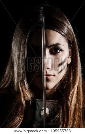 Woman Holding A Knife At The Middle Of Her Face