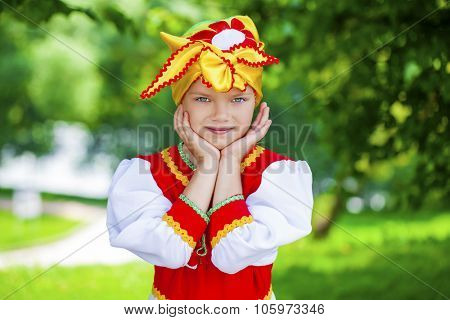 Close up Little girl is dressed in the Russian national dress in a summer park