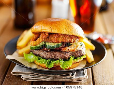 western barbecue burger with onion rings and sauce served with french fries