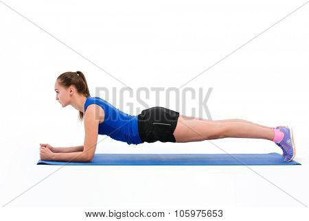 Portrait of a fitness woman doing plank exerises isolated on a white background