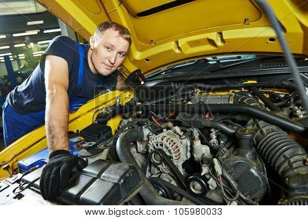 auto mechanic repairman tighten screw with spanner during automobile car maintenance at engine repair service station garage