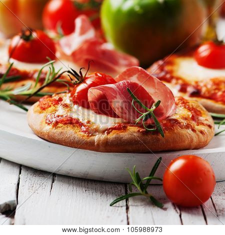 Mini Pizza With Mozzarella, Prosciutto And Tomato
