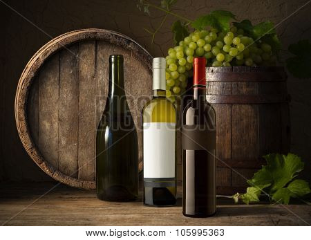 Still life with wine bottles, glasses and oak barrels  vintage