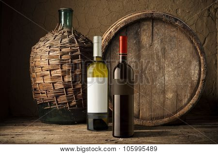 Still life with wine bottles, glasses and oak barrels  vintage