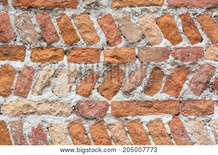 Old colorful brick wall texture background. Wall background for designers. Vertical and horizontal brick placement