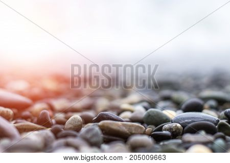 Wet Sea Pebbles With A Wave After A Storm With A Shallow Depth Of Field