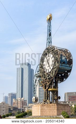 Tianjin, China - Nov 1, 2016: The Century Clock on a public park, along the Haihe River. Commercial buildings with modern architectural style in background.