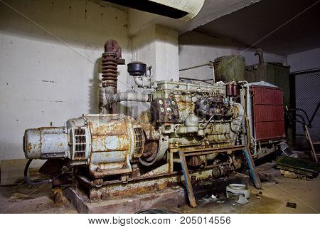 Rusty diesel generator in an abandoned Soviet bomb shelter