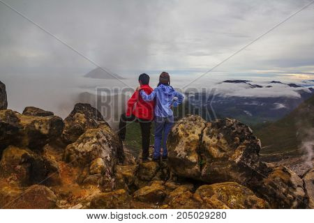 Couple standing on top of Mount Sibayak, Indonesia