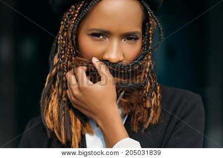 Shy African American female. Women secrets. Scared young black girl, teeth problems, introvert lady on dark background, silence concept
