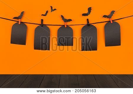Halloween fun orange background with black blank sale labels and dark wooden board mock up. Template for advertising design cover.