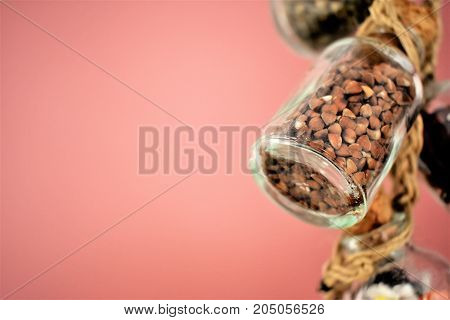 kitchen, glass jars, banks, bottle, tube, cork cover, gluten free food. cereals in jars. proper nutrition. black kidney. pink background. nude background. kitchen background. dusty background. black rice