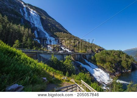 Summer Mountain Langfossen Waterfall On Slope Etne, Norway.