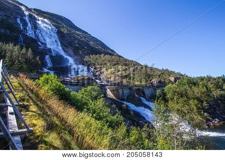 Summer Mountain Langfossen Waterfall On Slope Etne, Norway.