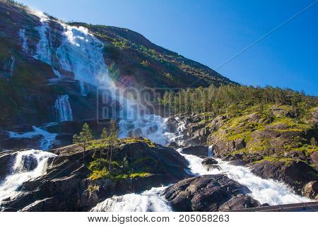 Summer Mountain Langfossen Waterfall On Slope Etne, Norway.