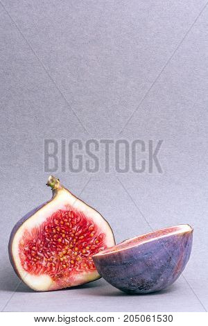 figs cut into two parts. Juicy fruit. Bright colors. Blurred background.