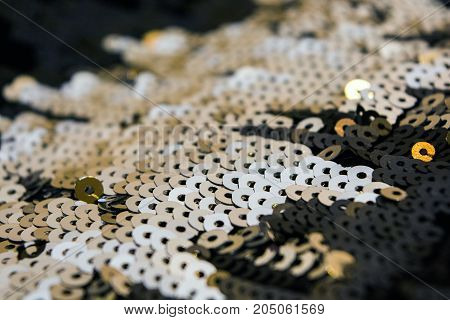 sequins. Paillettes. Decoration cloth. Golden shine. Glamour background.