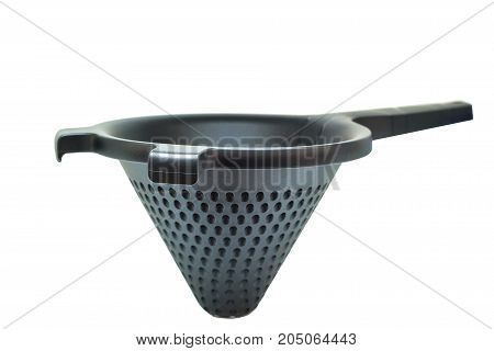 Closeup of black plastic conical utensil with perforation