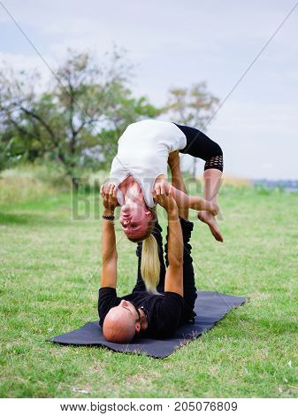 Photo of practicing yoga outdoor. Doing yoga fitness. Exercise for relax and healthy body.