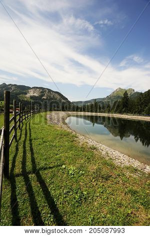 Wooden fence in the Alps under blue sky