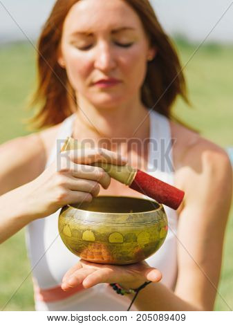 Close-up image of girl's meditation at the health club outside with personal trainer, learning the correct form.