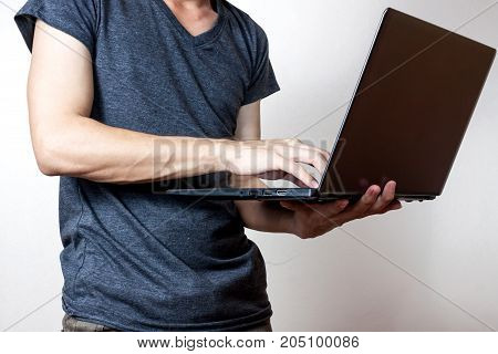 young businessmen standing and using tablet in office together