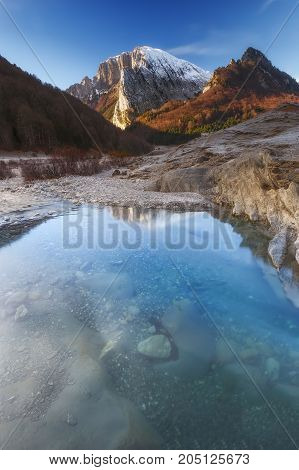 Ezcaurre peak over the river in Zuriza in Pirineos