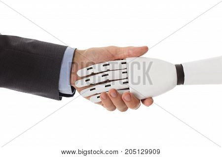Close-up Of Businessperson Shaking Hands With Robot