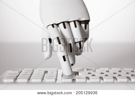 Close-up Of Robotic Hand Pressing Enter Key On Keyboard