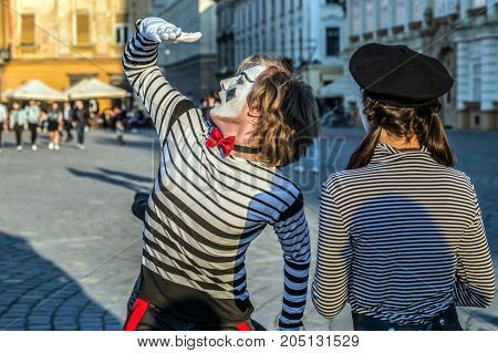 TIMISOARA ROMANIA - MARCH 31 2017: Pantomime couple with painted face present on the street inside the CheckART Carnival organized by the City Hall Timisoara. Union Square.