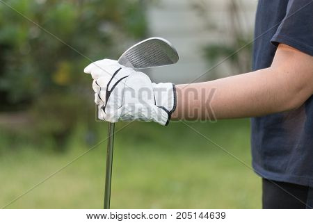 Golfer Wearing White Glove Holdiing Golf Club