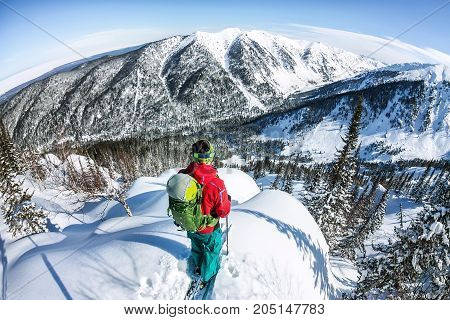 Man Standing At Top Of Ridge. Ski Touring In Mountains. Adventure Winter Freeride Extreme Sport