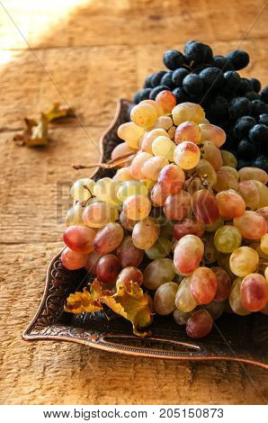 Two Type Of Fresh Ripe Grapes Blue And Green On A Vintage Old Tray. Close Up.