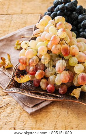 Two Type Of Fresh Ripe Grapes Blue And Green On A Vintage Old Tray. Close Up.