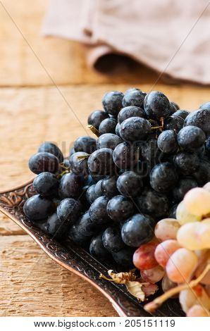 Two Type Of Fresh Ripe Grapes Blue And Green On A Vintage Old Tray. Close Up.