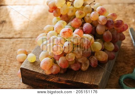 Brunch Of Fresh Ripe Grape On A Wooden Background. Close Up.