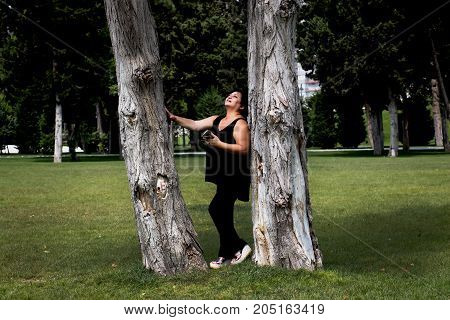 Woman talking on mobile phone in nature on a summer morning