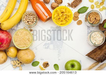 Assortment of products rich of complex carbohydrates. Healthy food on white stone background. Space for text