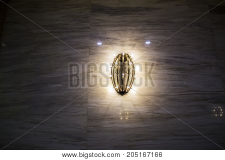 The illuminated sconce on the wall is reflective light