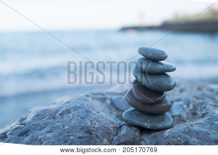 Pebble tower on the seaside. Reax concept