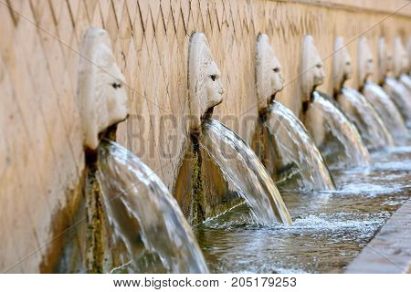 Old venetian fountain with lion heads springs pure drinking water in Spili Crete island Greece