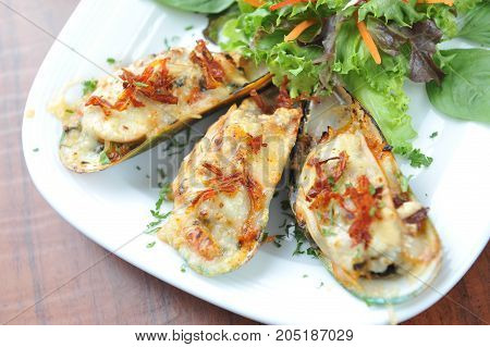 mussels under cheese and salad Mussels baked