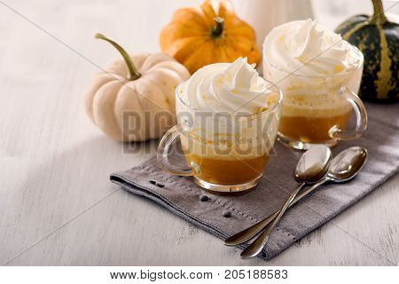 Pumpkin latte hot caffee drink with pumpkins whipped cream and spices