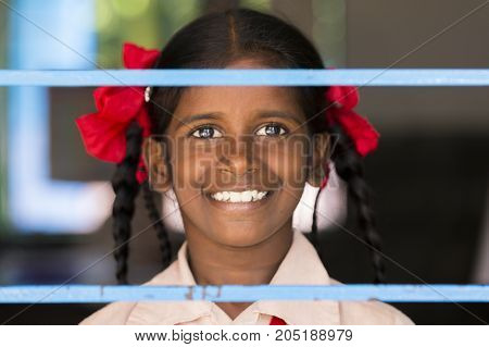 PONDICHERY PUDUCHERY INDIA - SEPTEMBER 04 2017. Unidentified child at schhol behind the window