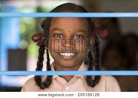 PONDICHERY PUDUCHERY INDIA - SEPTEMBER 04 2017. Unidentified child at schhol behind the window