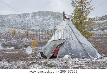 Tsaatan Boy Looing Out Of The Family Yurt In A Cold Autumn Morning