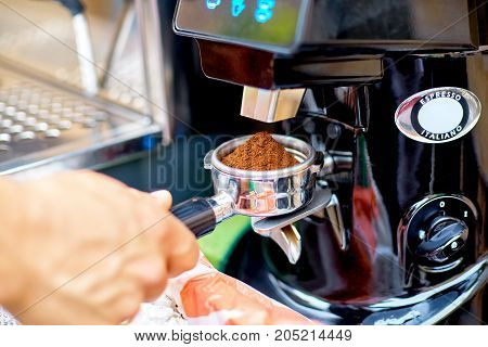 Coffee Grinder Grinding Freshly Roasted Coffee Beans Into A Coff