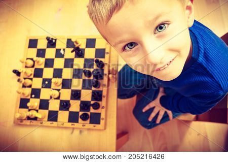 Young Kid Boy Playing Chess Having Fun