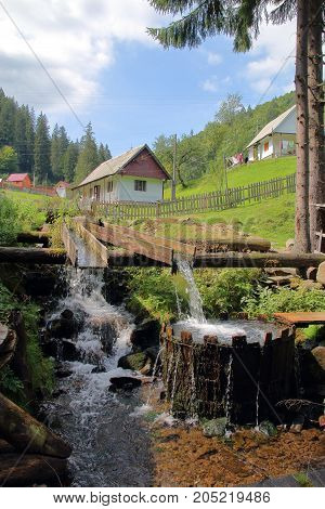 The picture was taken in Ukraine in the Carpathian Mountains. The picture shows the original village vat for washing. The vat is filled with water from a mountain stream in a natural way.